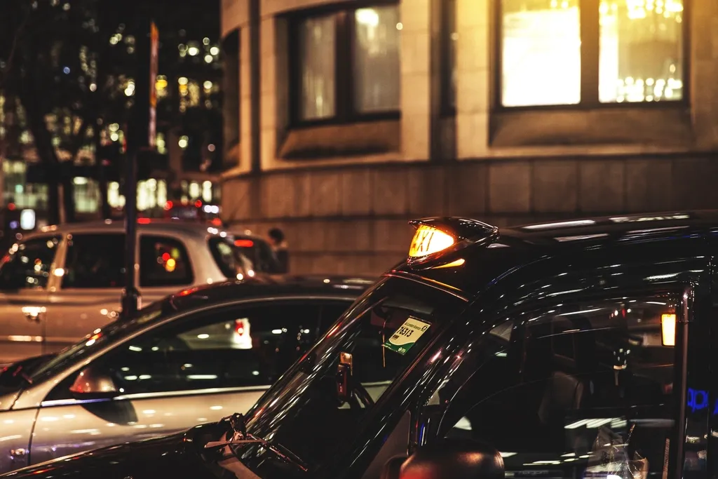 Cars parked on a city street at night