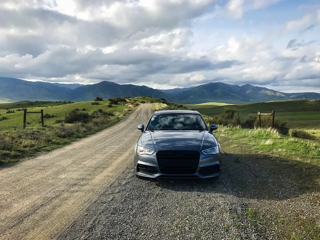 A dark sedan on a country road