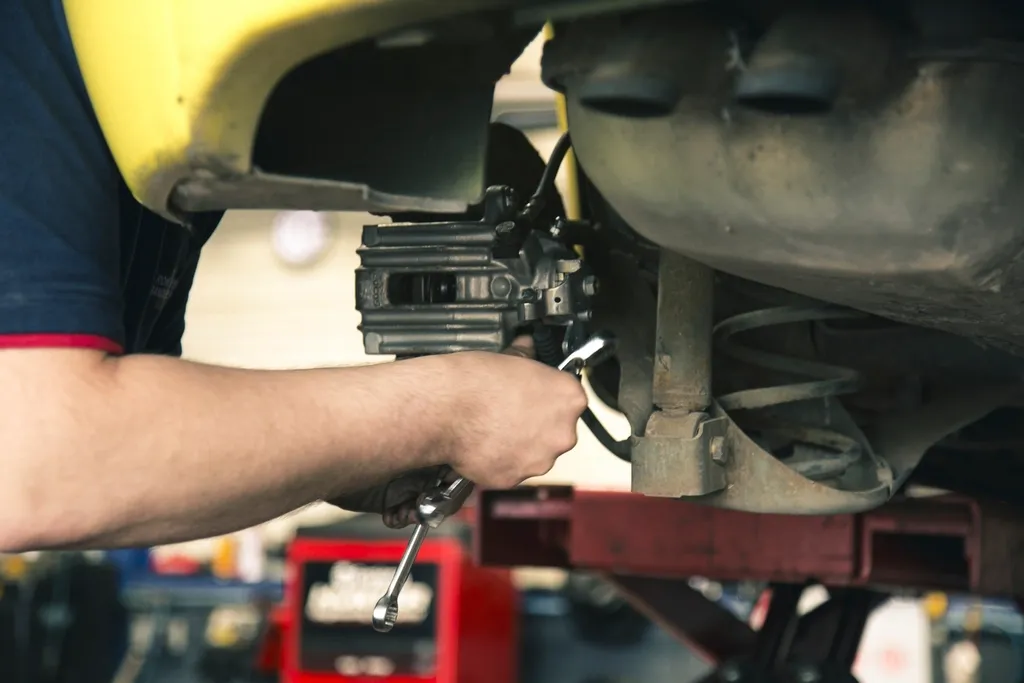Mechanic working under a car